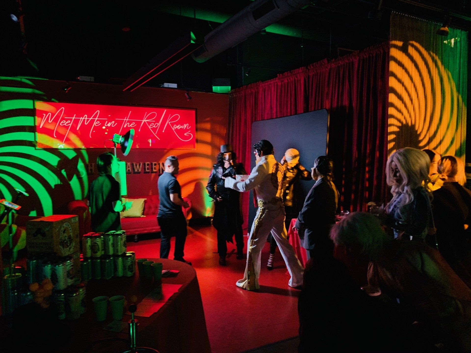 A group of people are standing in a dark room.