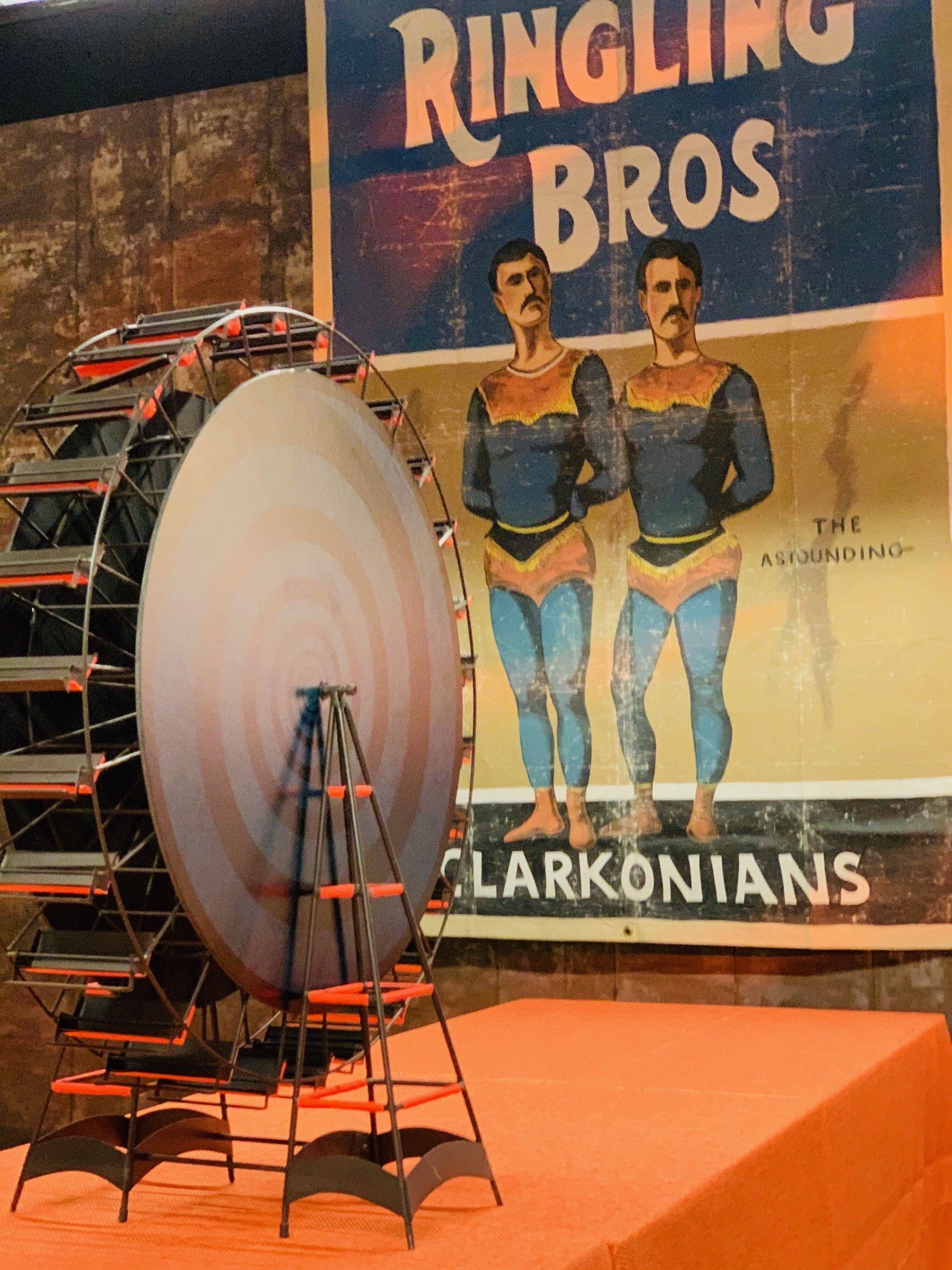 A poster for the ringling bros is hanging on a wall