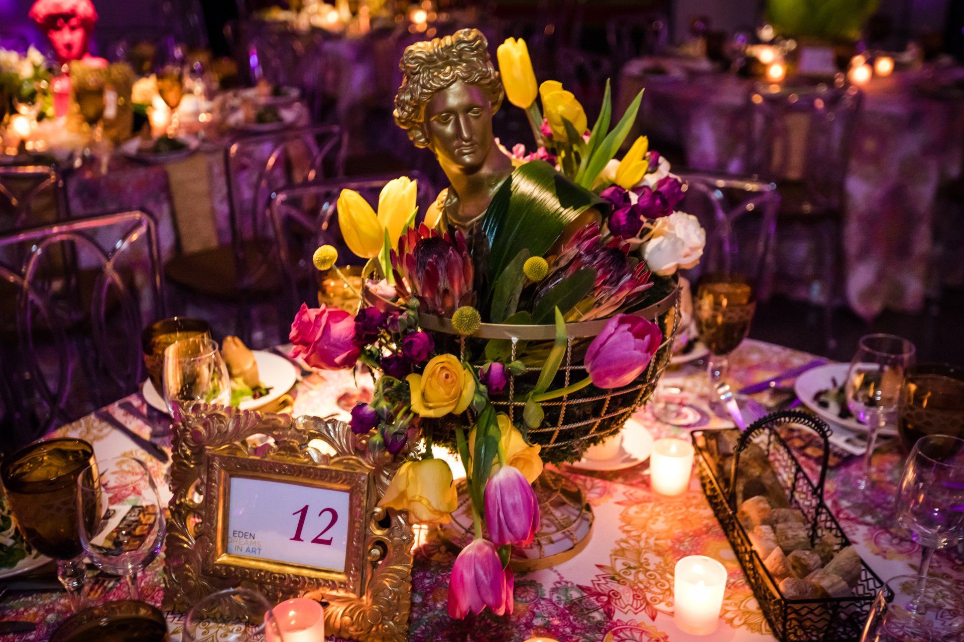 A table with flowers and candles and a table number 12