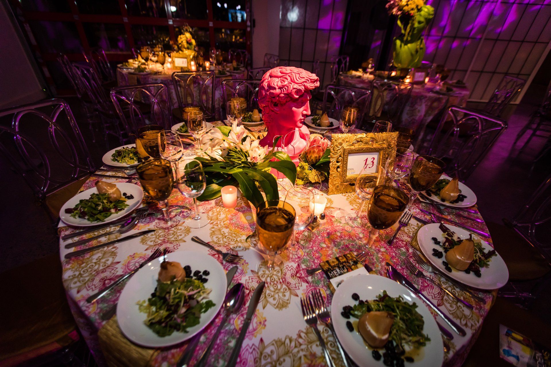 A table set for a party with plates of food and candles.