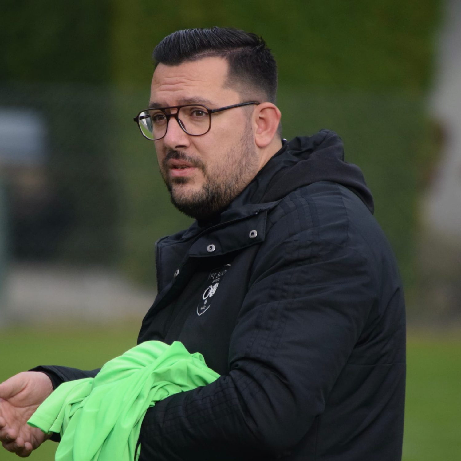 Un homme portant un chapeau sur lequel est écrit lfc