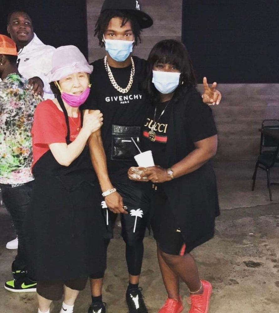 A group of people wearing face masks are posing for a picture