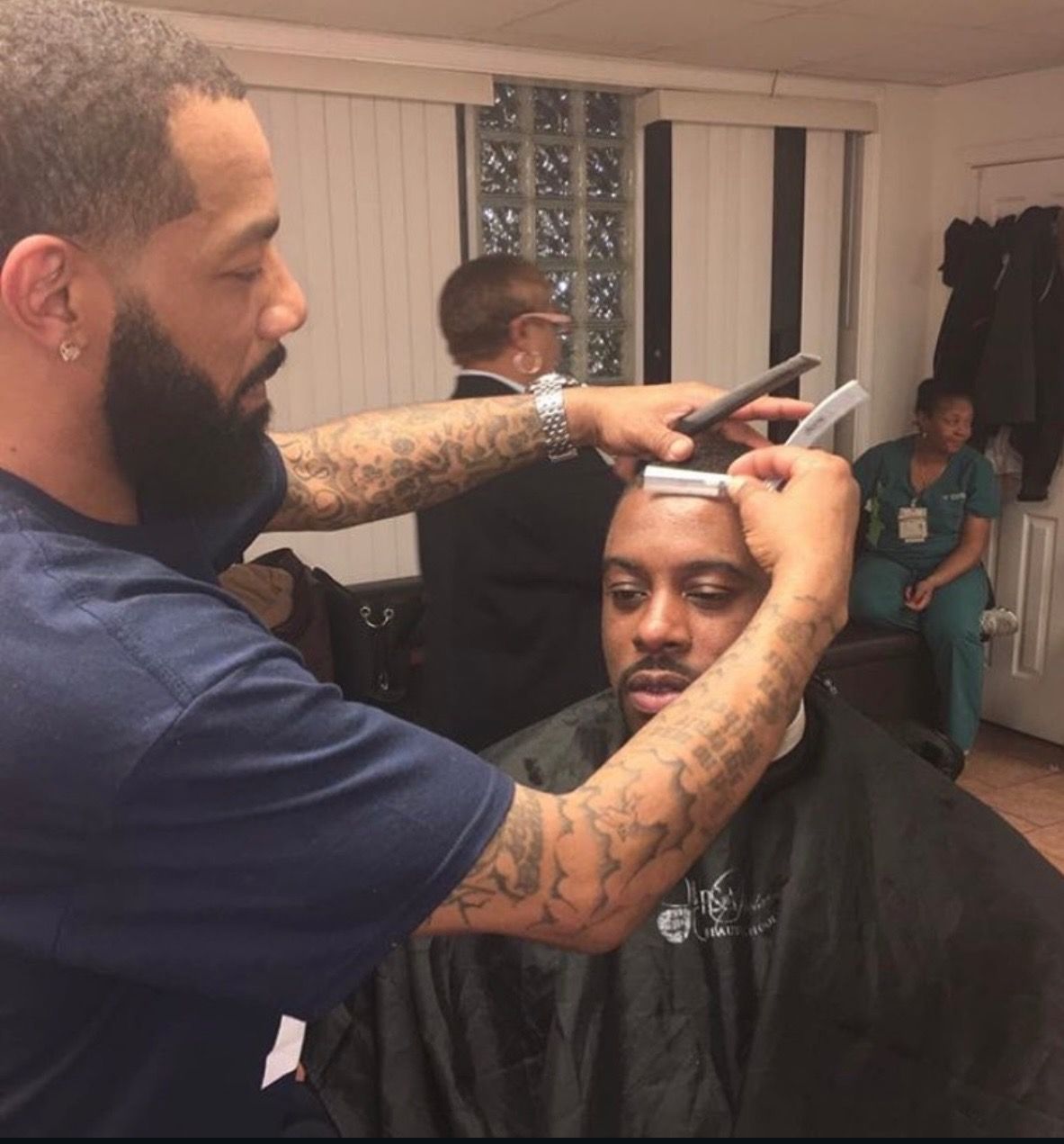 A man is getting his hair cut by a barber