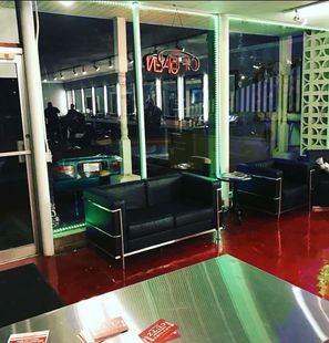 A room with a couch and chairs and a sign that says vegas