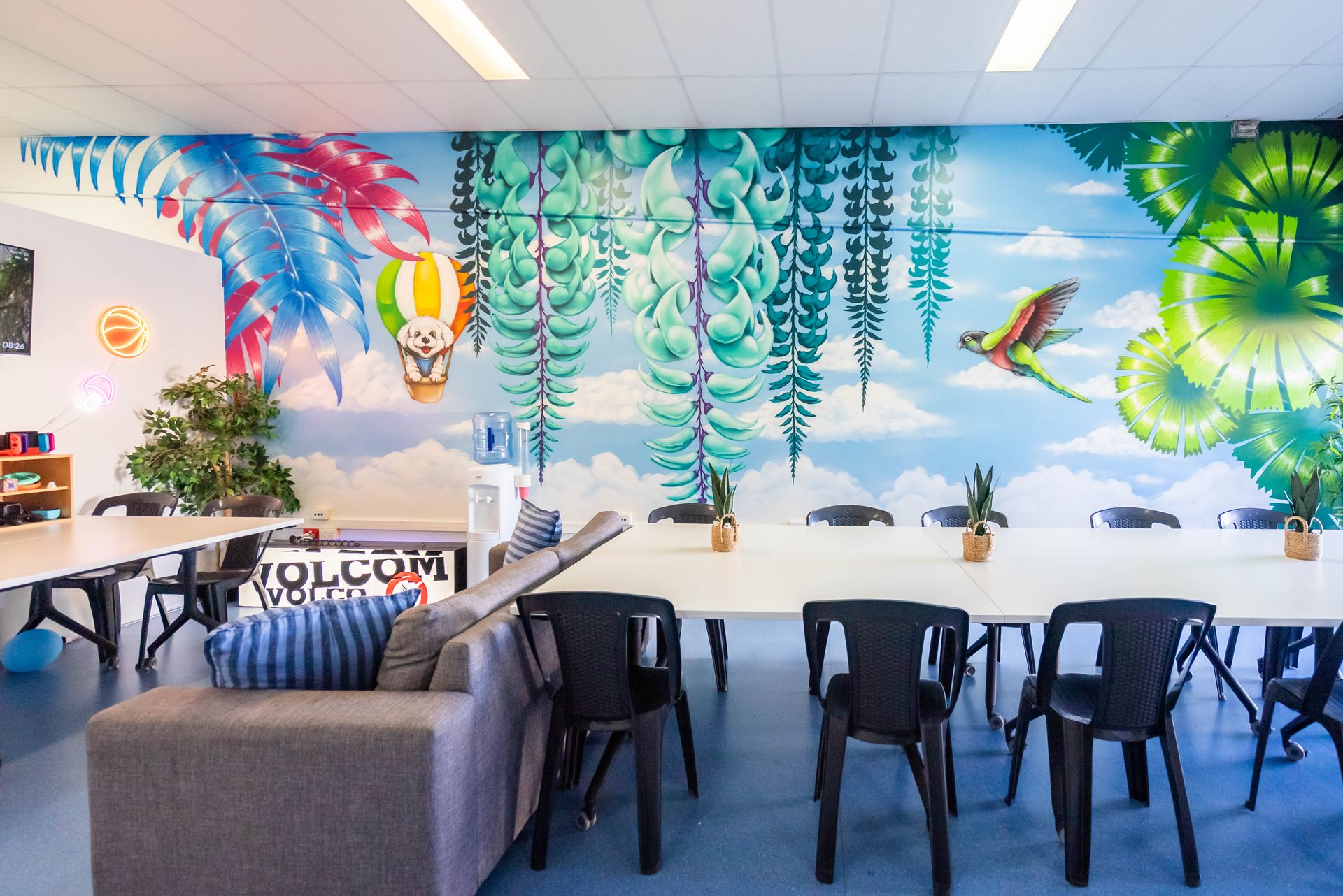 Bright Tropical Mural in a Casual Lounge With Sofas, Chairs, and a Table — Sparks Social Abilities in Bungalow, QLD