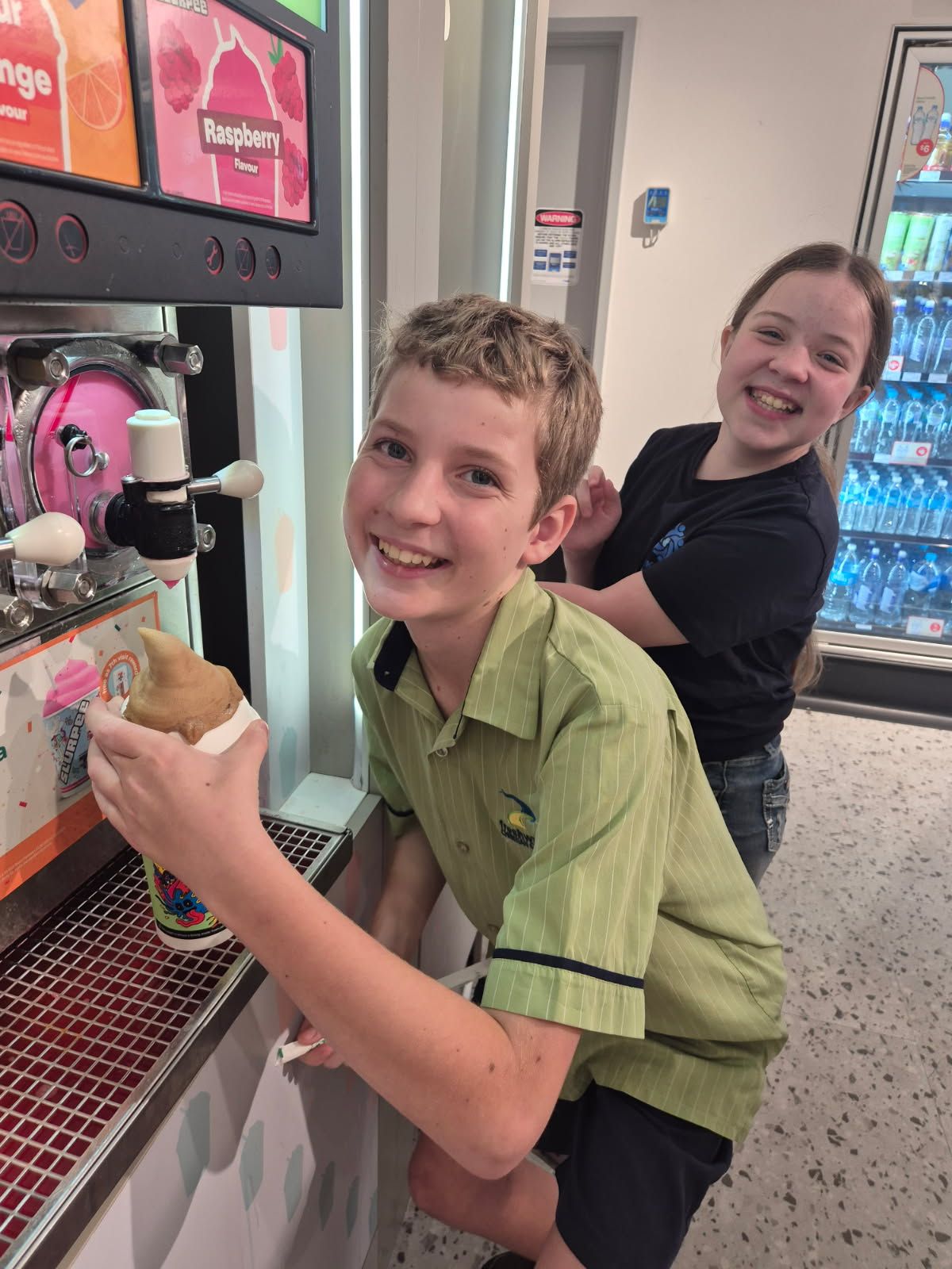 Two People Smiling at an Ice Cream Machine — Sparks Social Abilities in Bungalow, QLD
