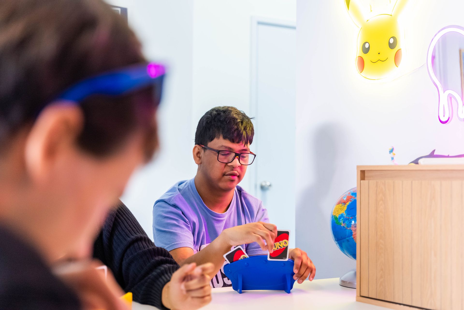 People at a Table Building With Colorful Cards in a Bright Room — Sparks Social Abilities in Bungalow, QLD