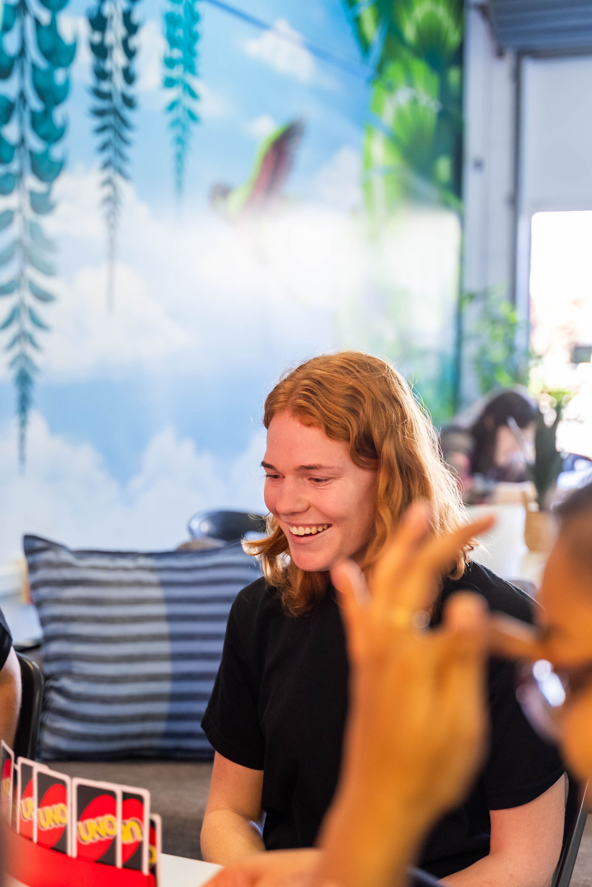 Smiling Person in a Black Shirt at a Table — Sparks Social Abilities in Bungalow, QLD