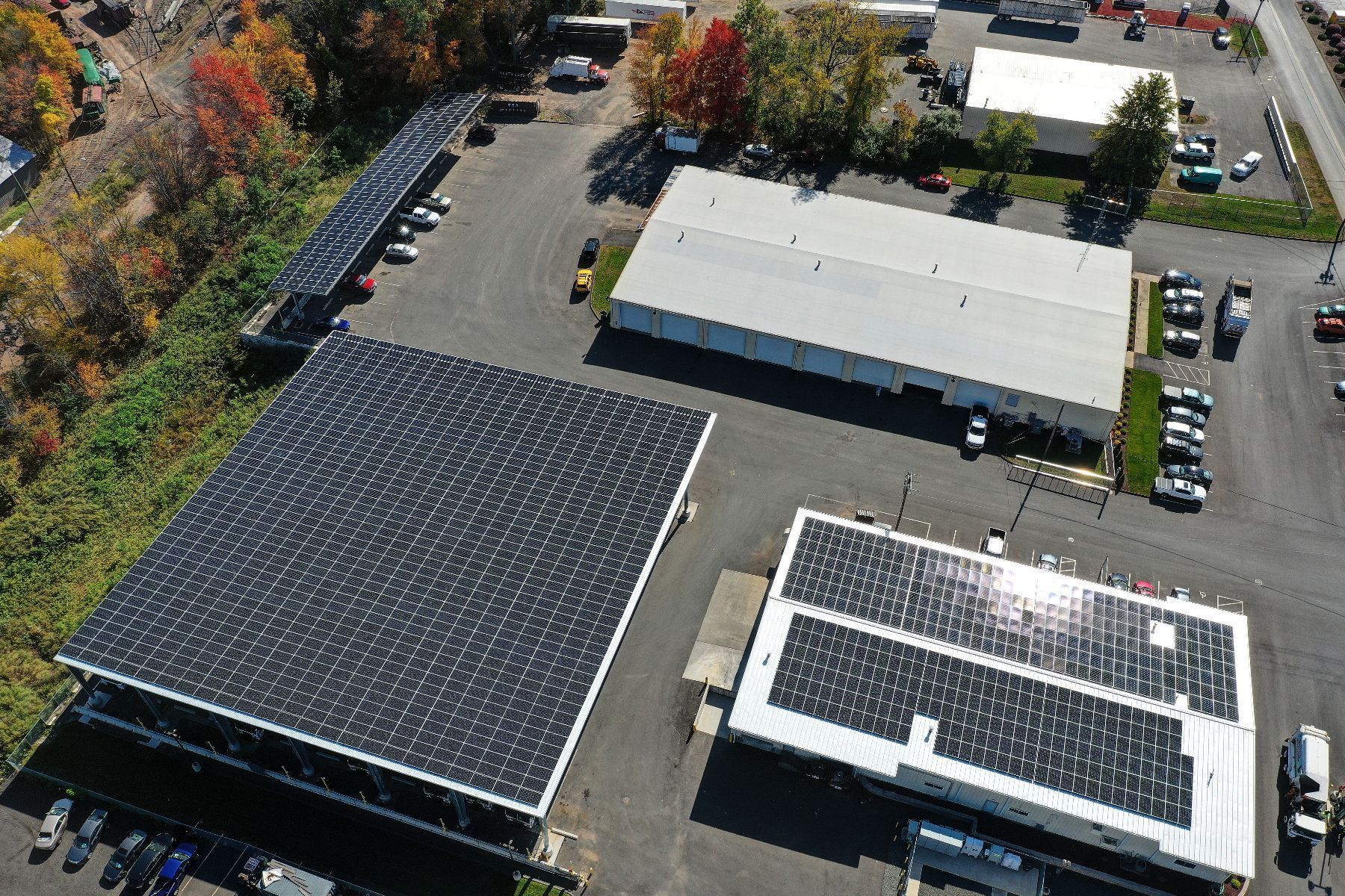 An aerial view of a building with solar panels on the roof.