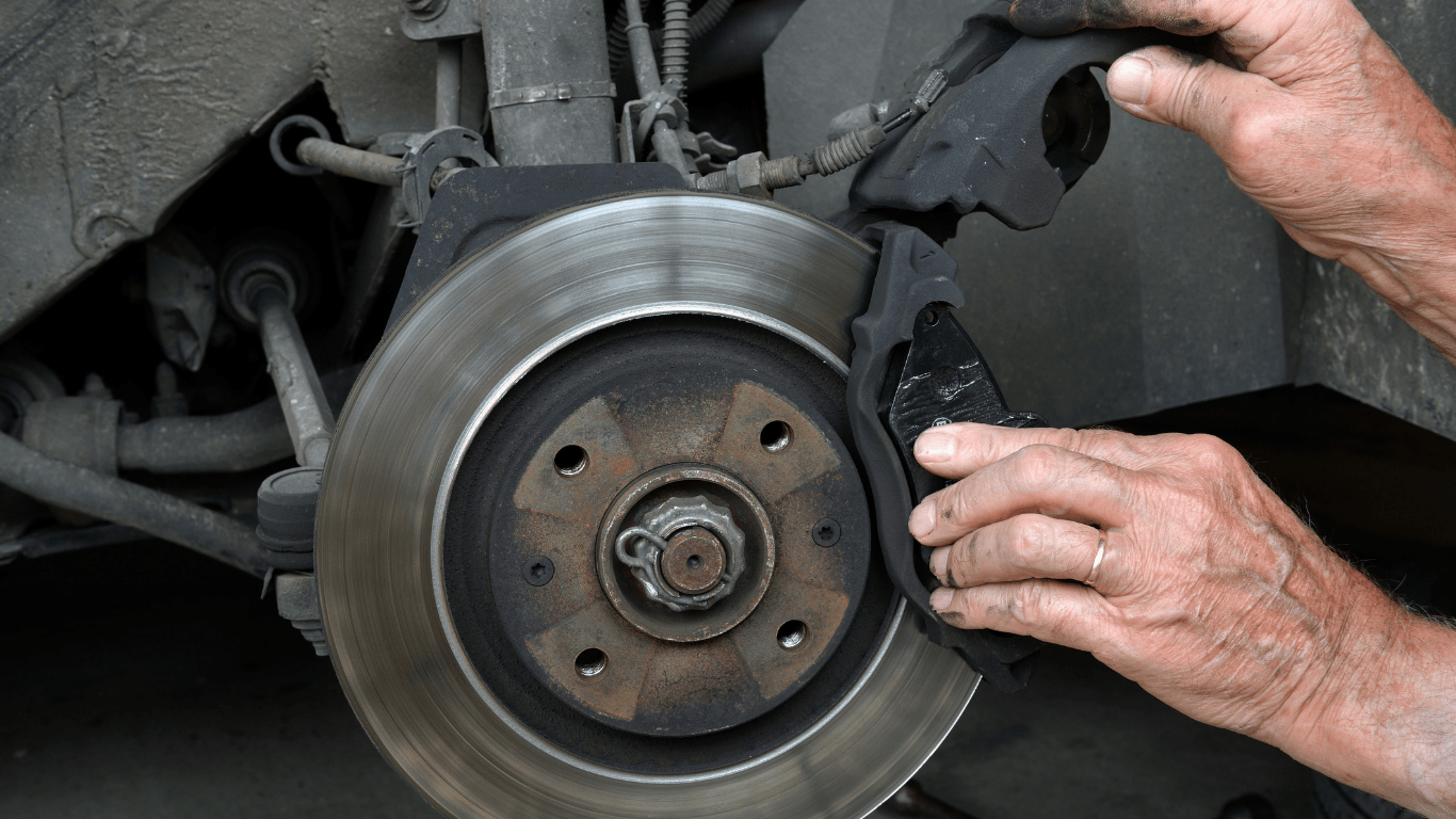 a picture of a mechanic changing brake pads