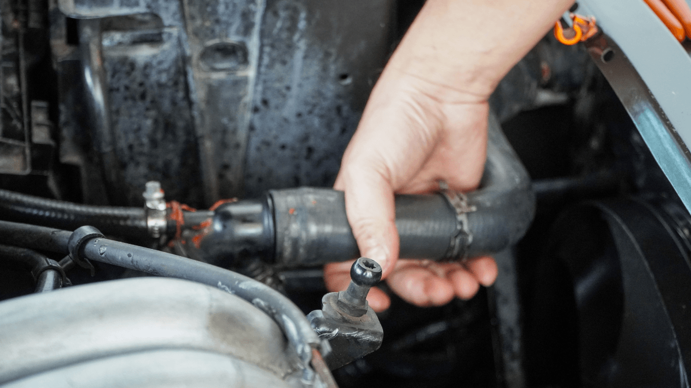 a mechanic fixing a radiator hose