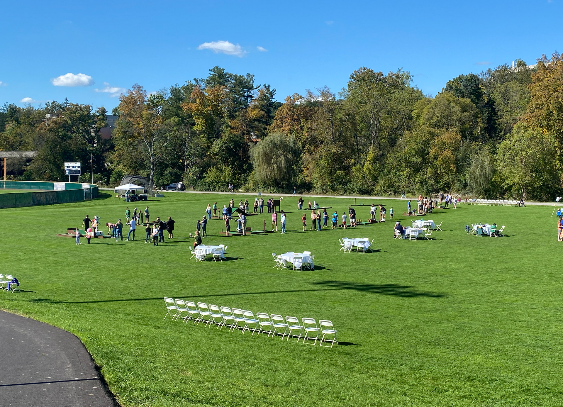 A group of people are standing in a grassy field