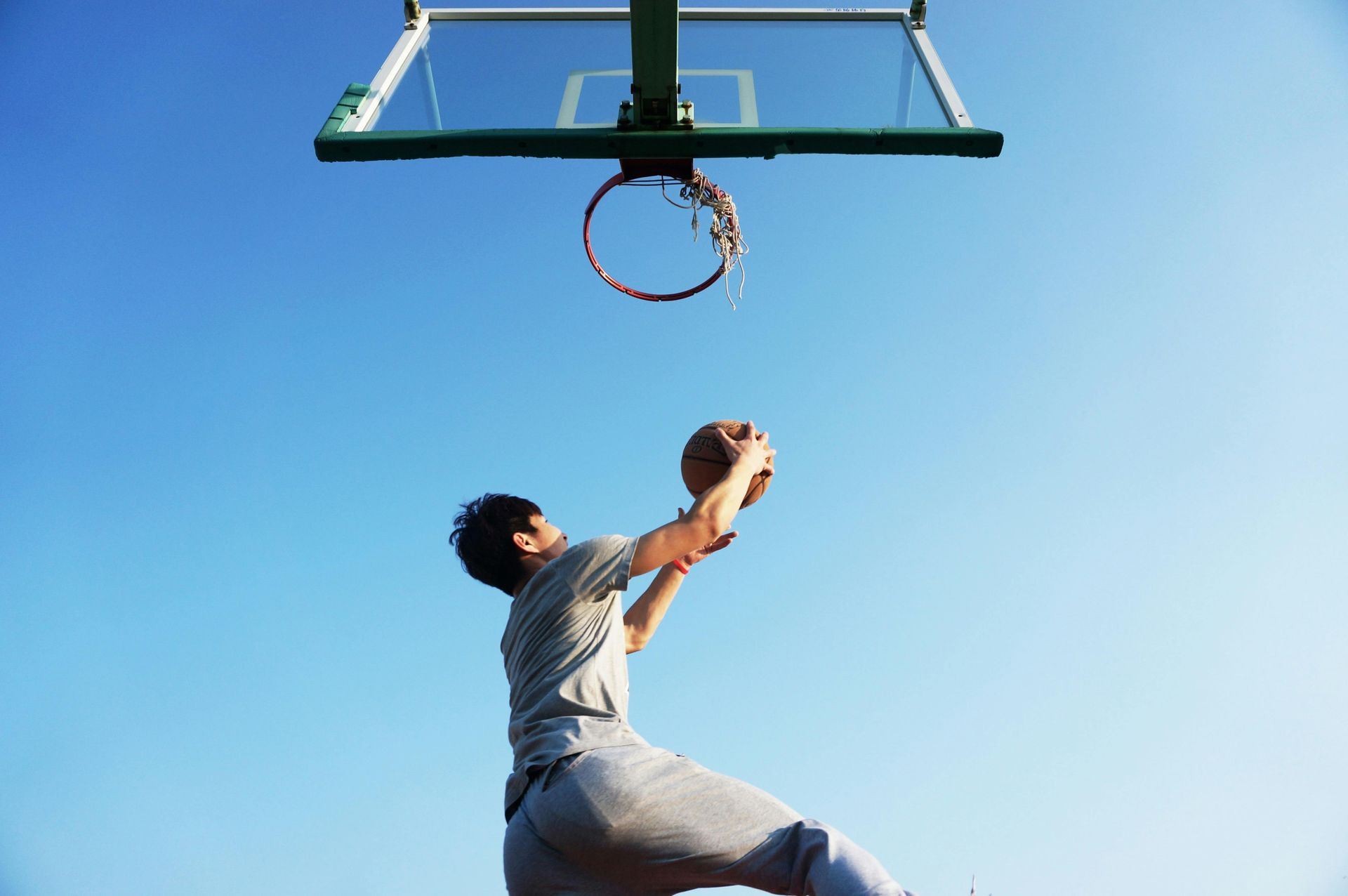 Person playing basketball on an outdoor court