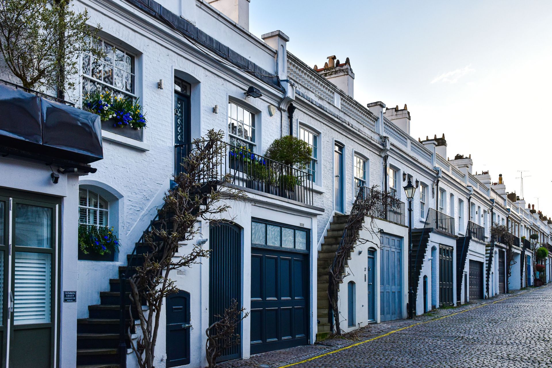 Row of white London mews houses
