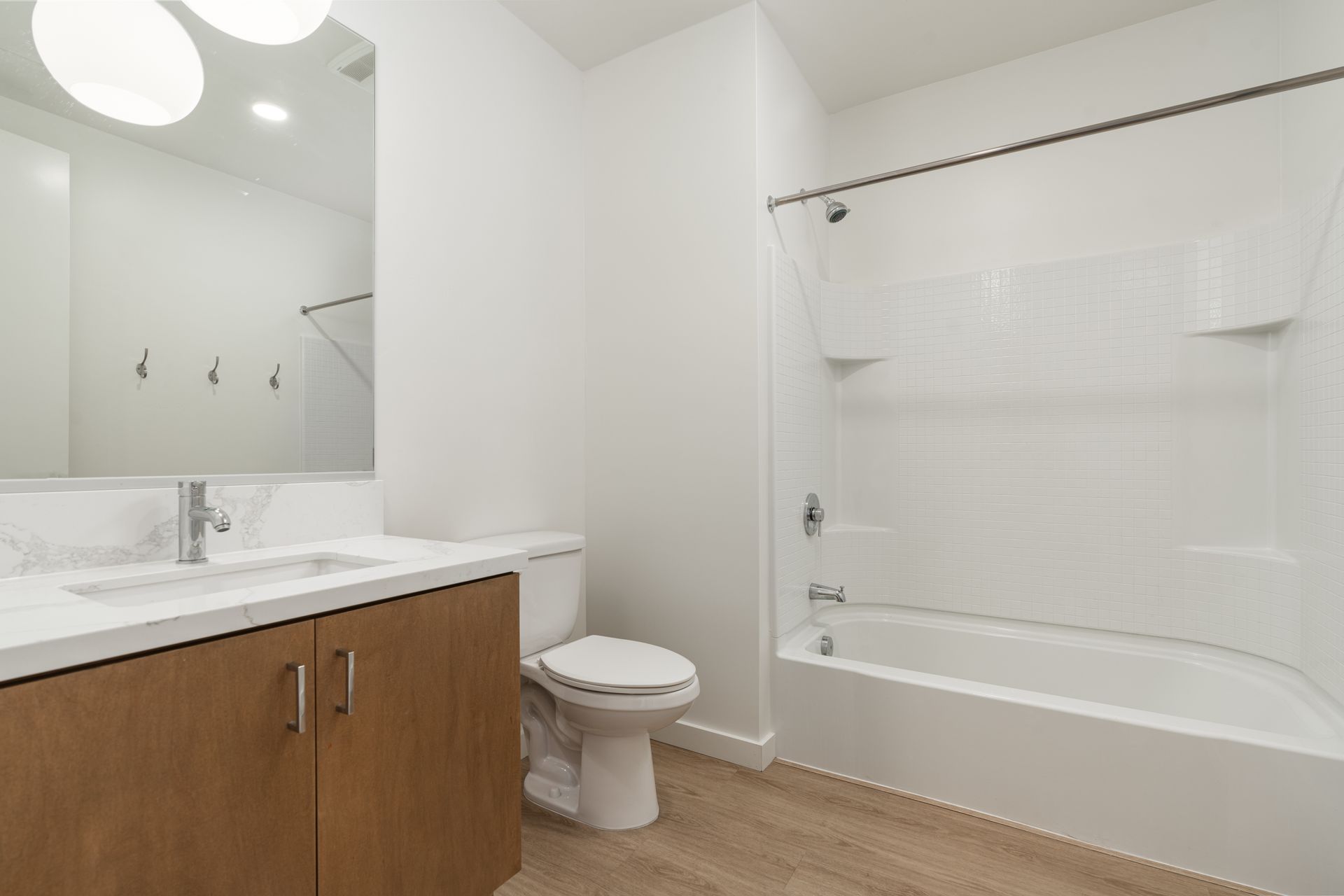 A bathroom with a toilet , sink , and bathtub.