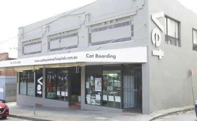A building with a sign that says cat boarding on it.