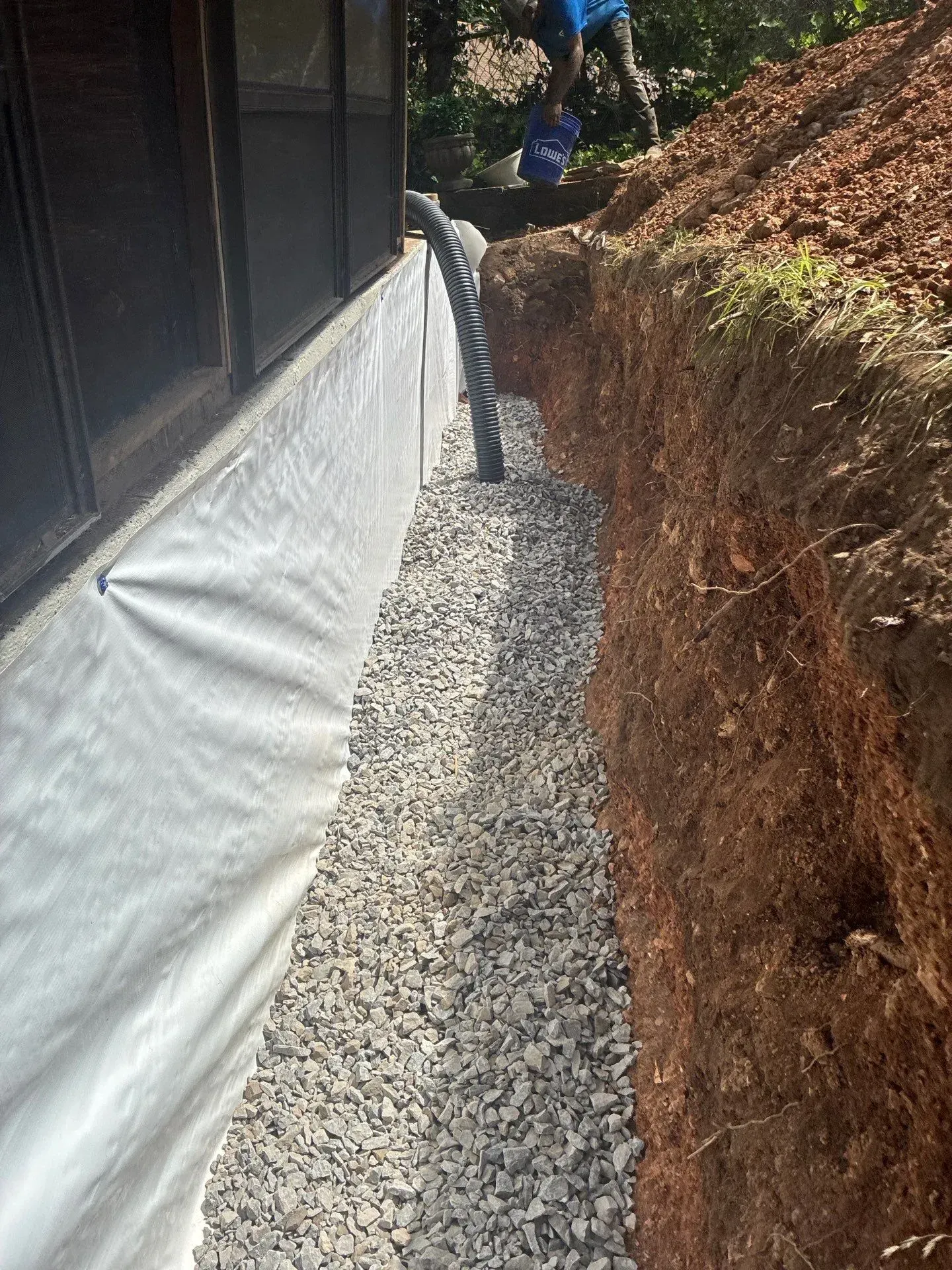 Interior basement waterproofing drainage channel installation by H2O Waterproofing in Alabama