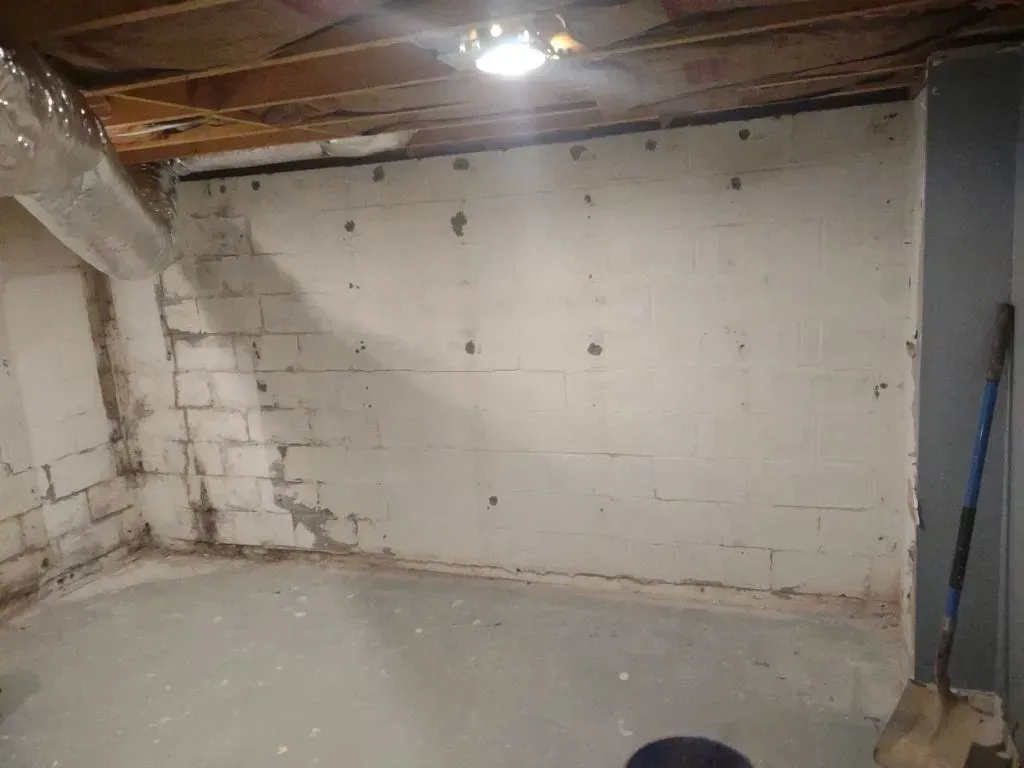 Basement walls, showing signs of water damage due to hydrostatic pressure.