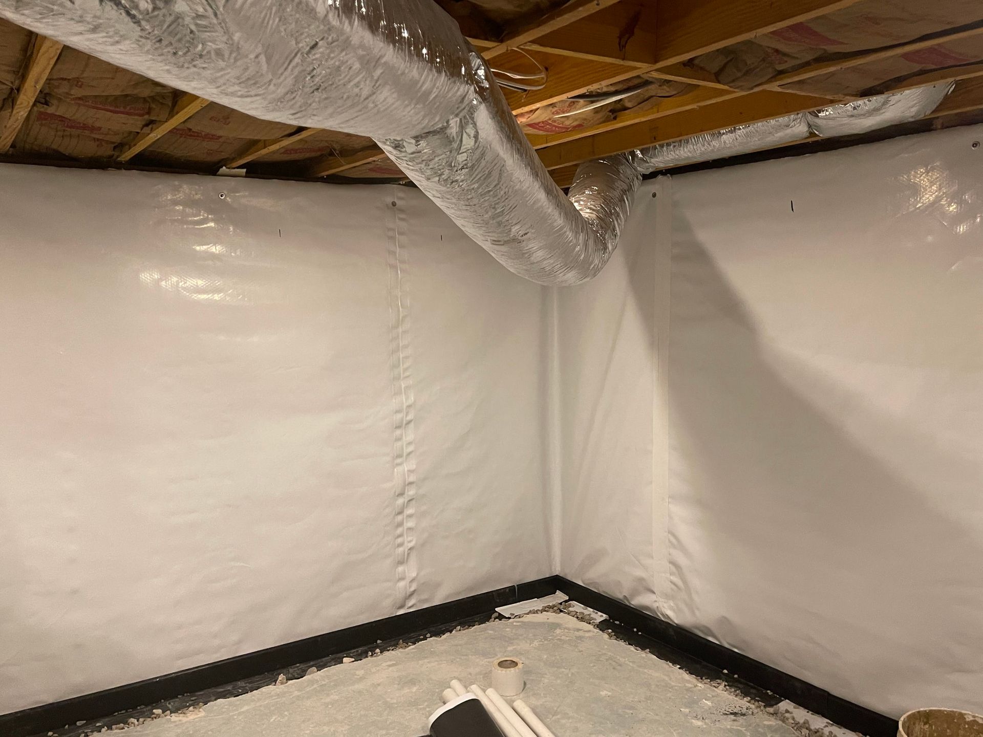 Installation of a vapor barrier for basement waterproofing by H2O Waterproofing in Vestavia Hills AL