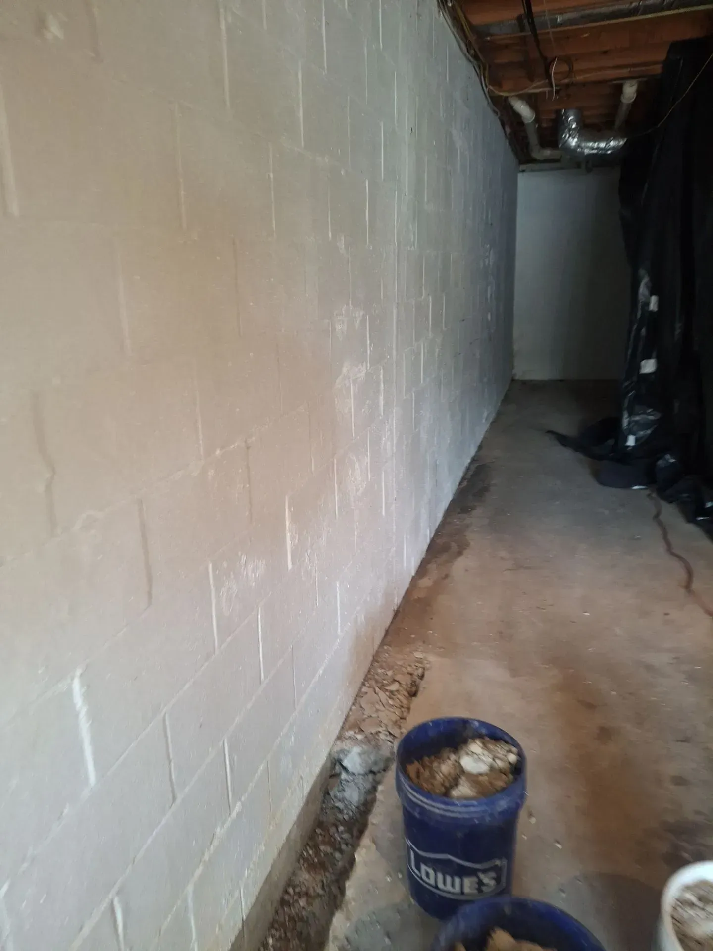 Interior basement waterproofing drainage channel installation by H2O Waterproofing in Alabama