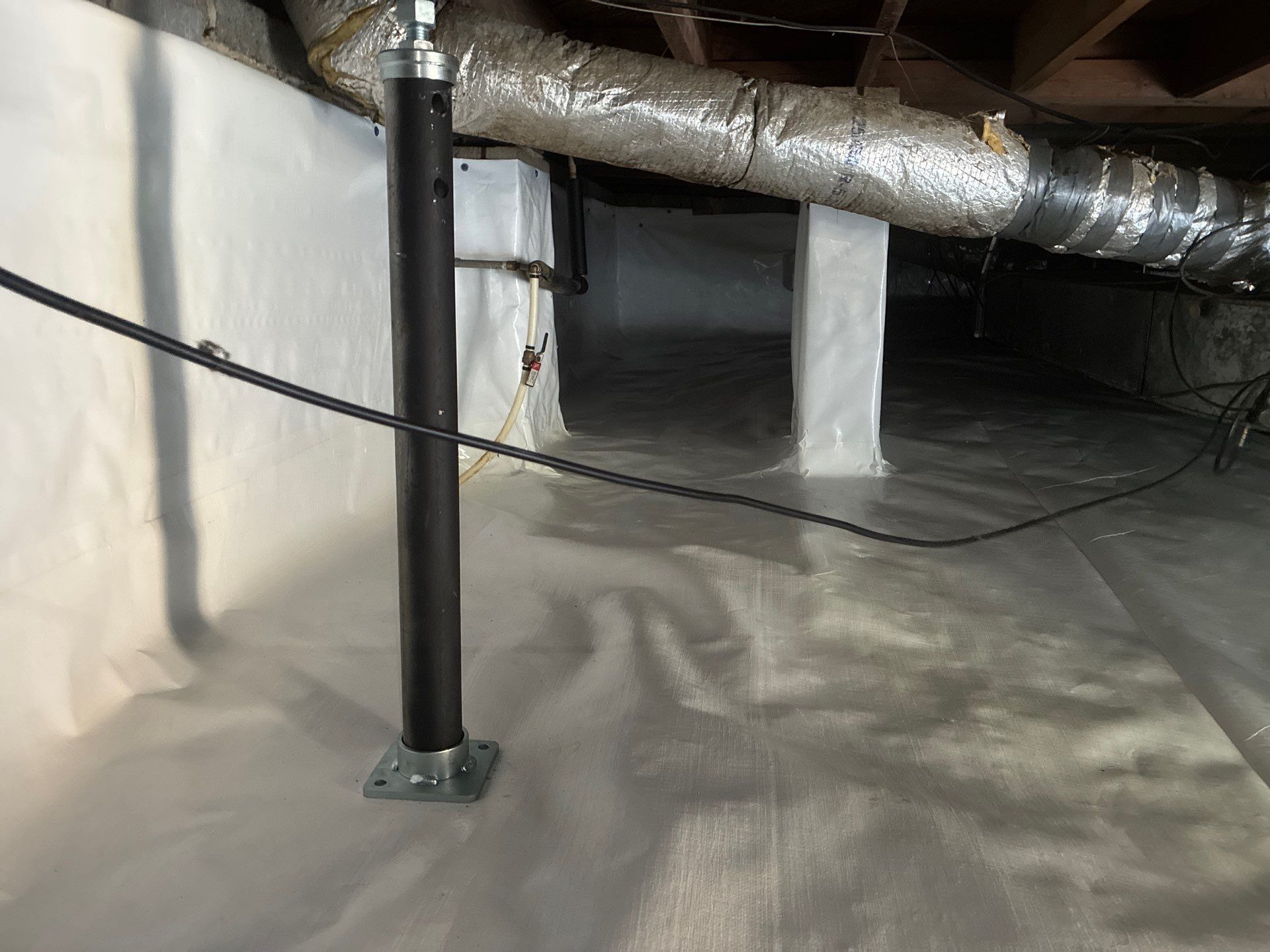 New adjustable crawl space stabilizer supporting the floor system after repair
