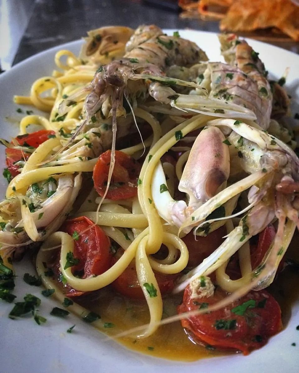 Pasta with clams and cherry tomatoes in a light sauce on a plate