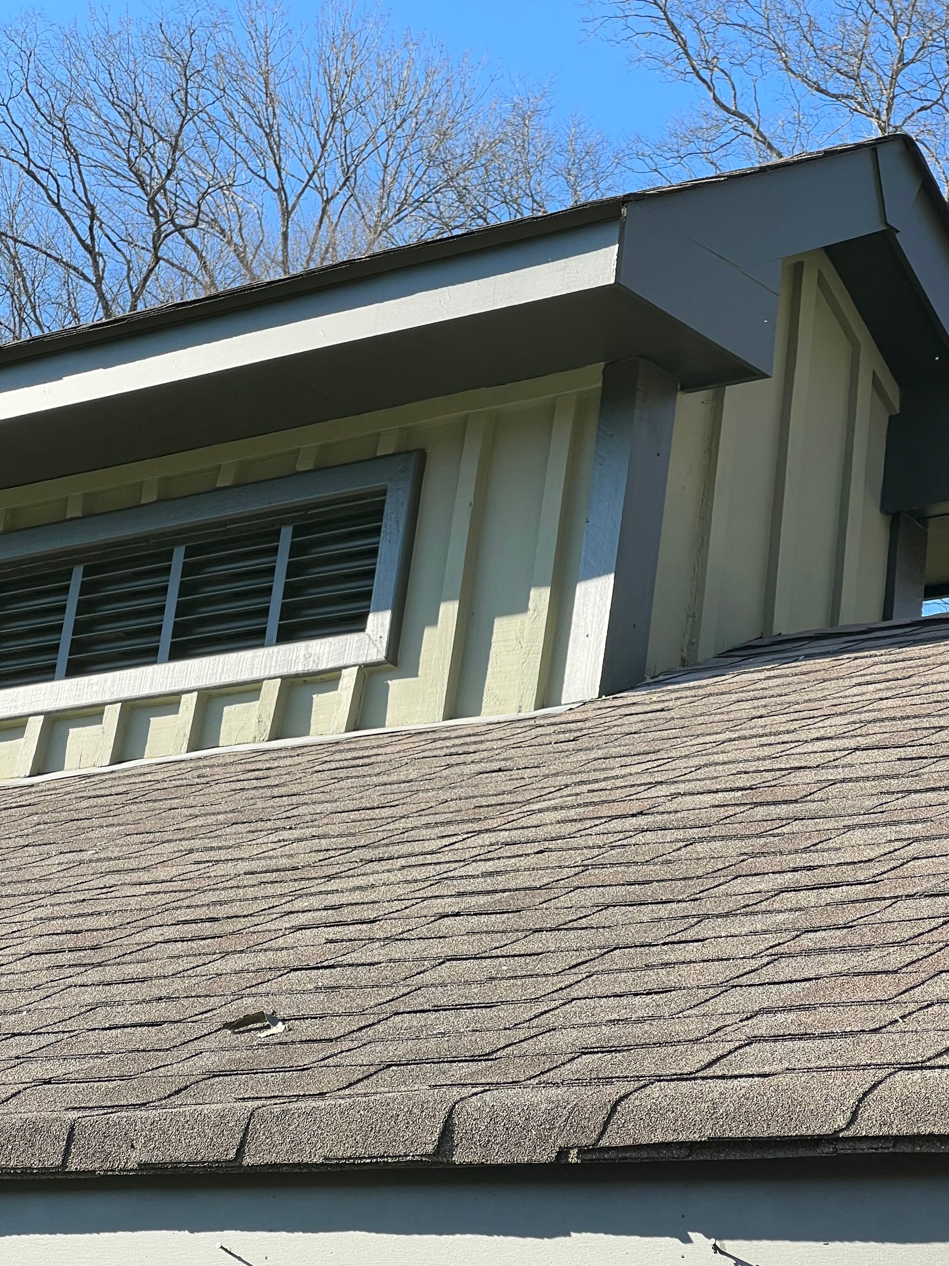 A house with a roof that has a window on it