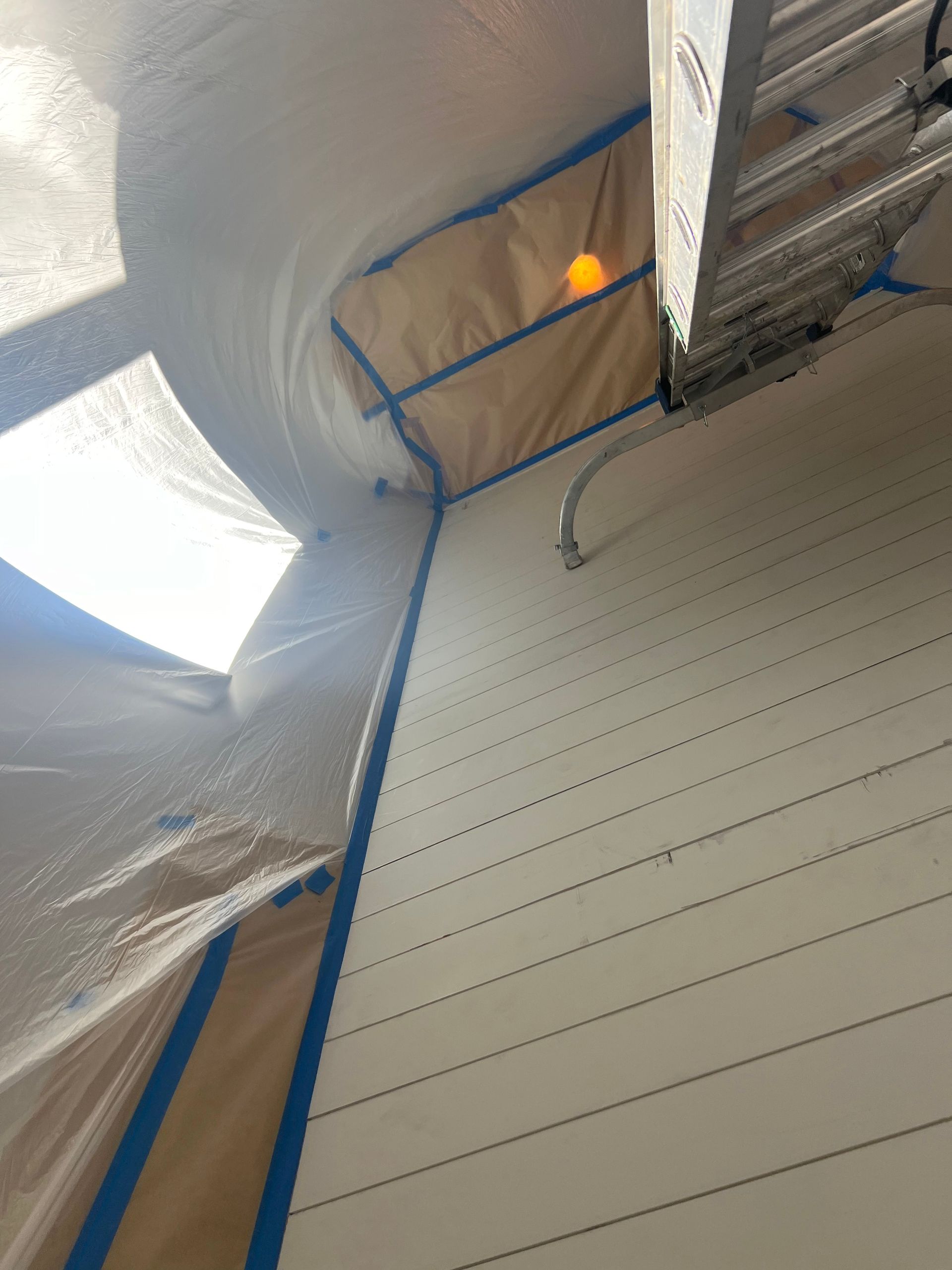 A ladder is hanging from the ceiling of a building.