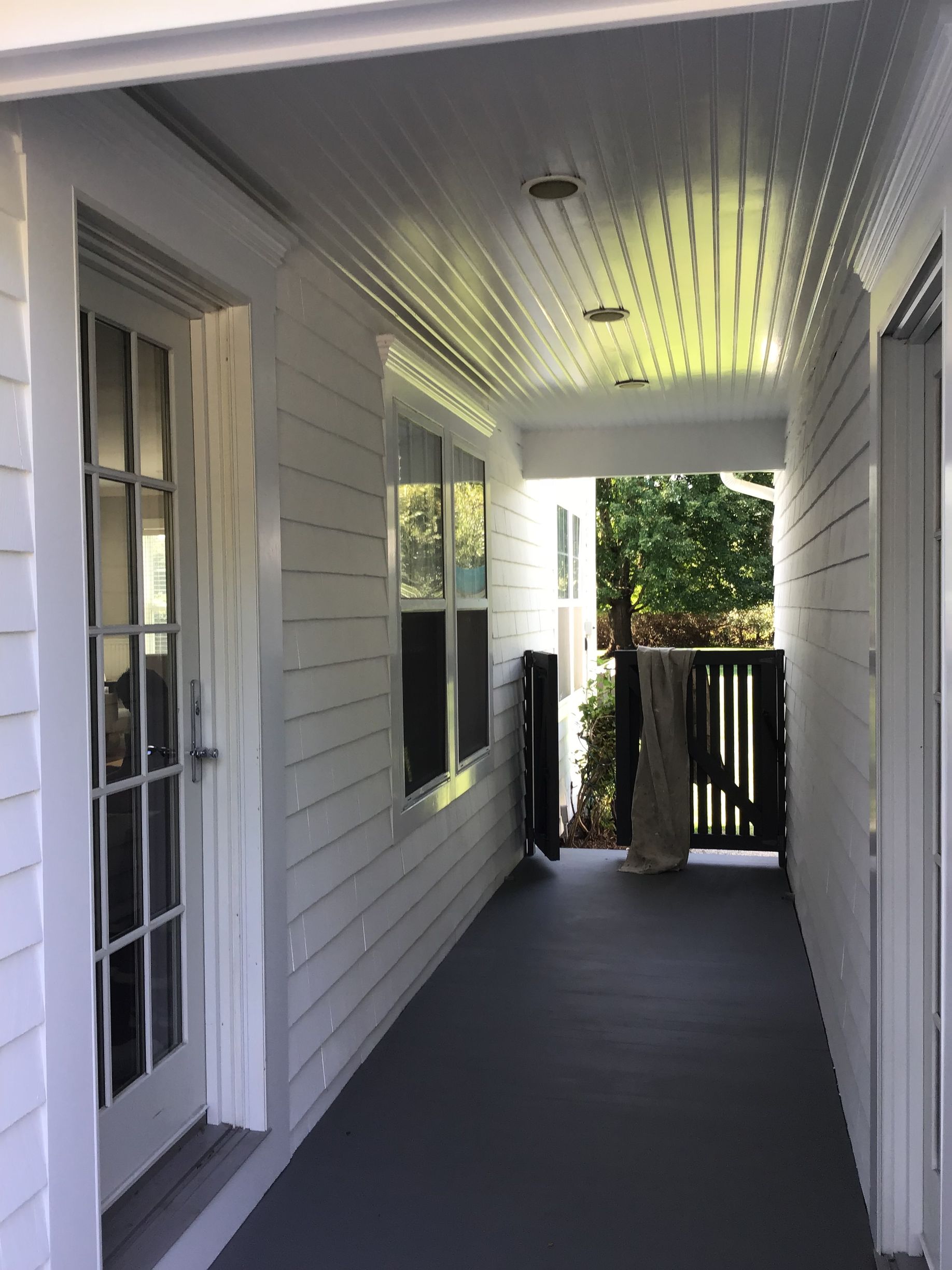 A white house with a porch and a gate