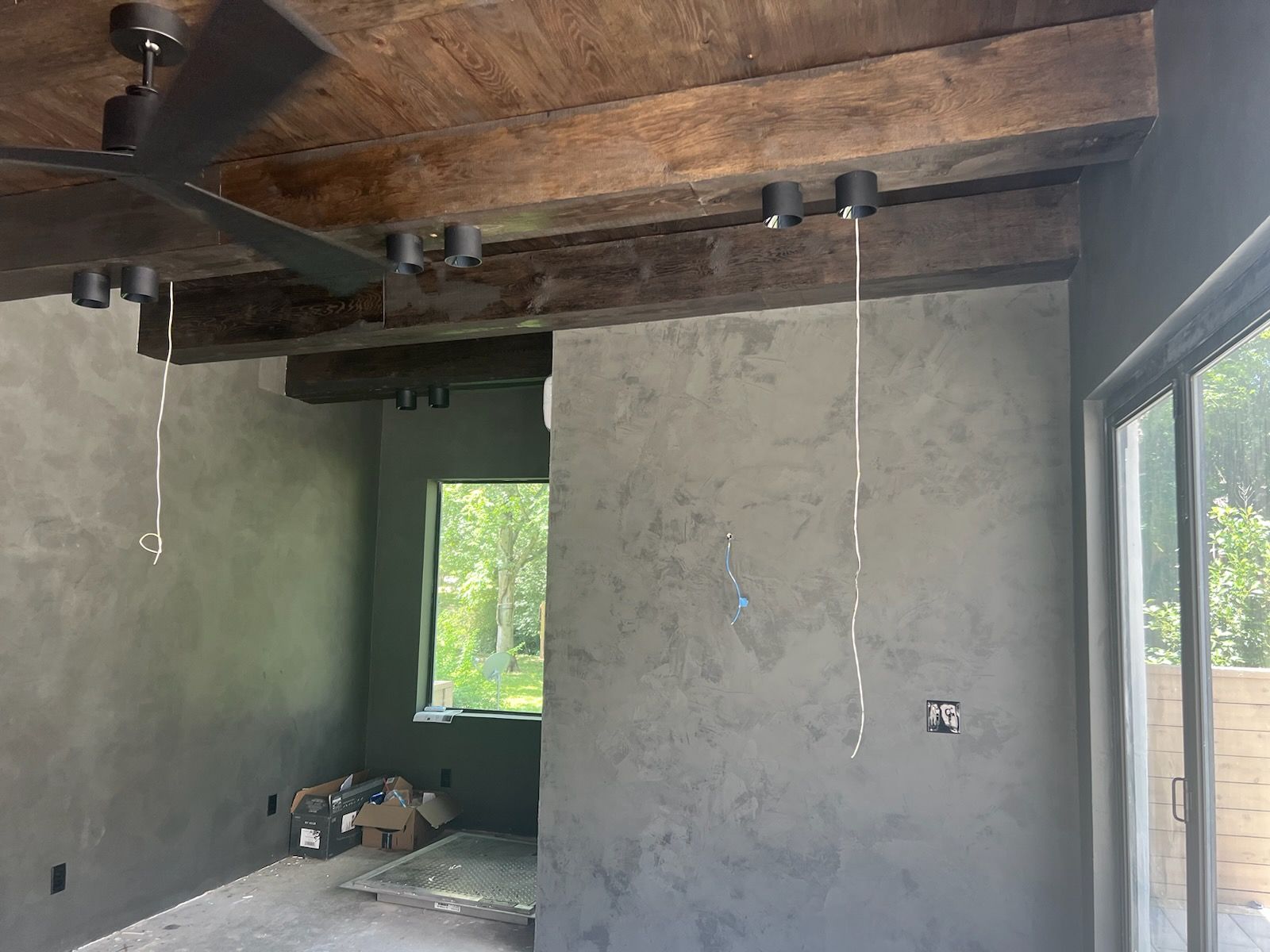 A room with a ceiling fan and a window.