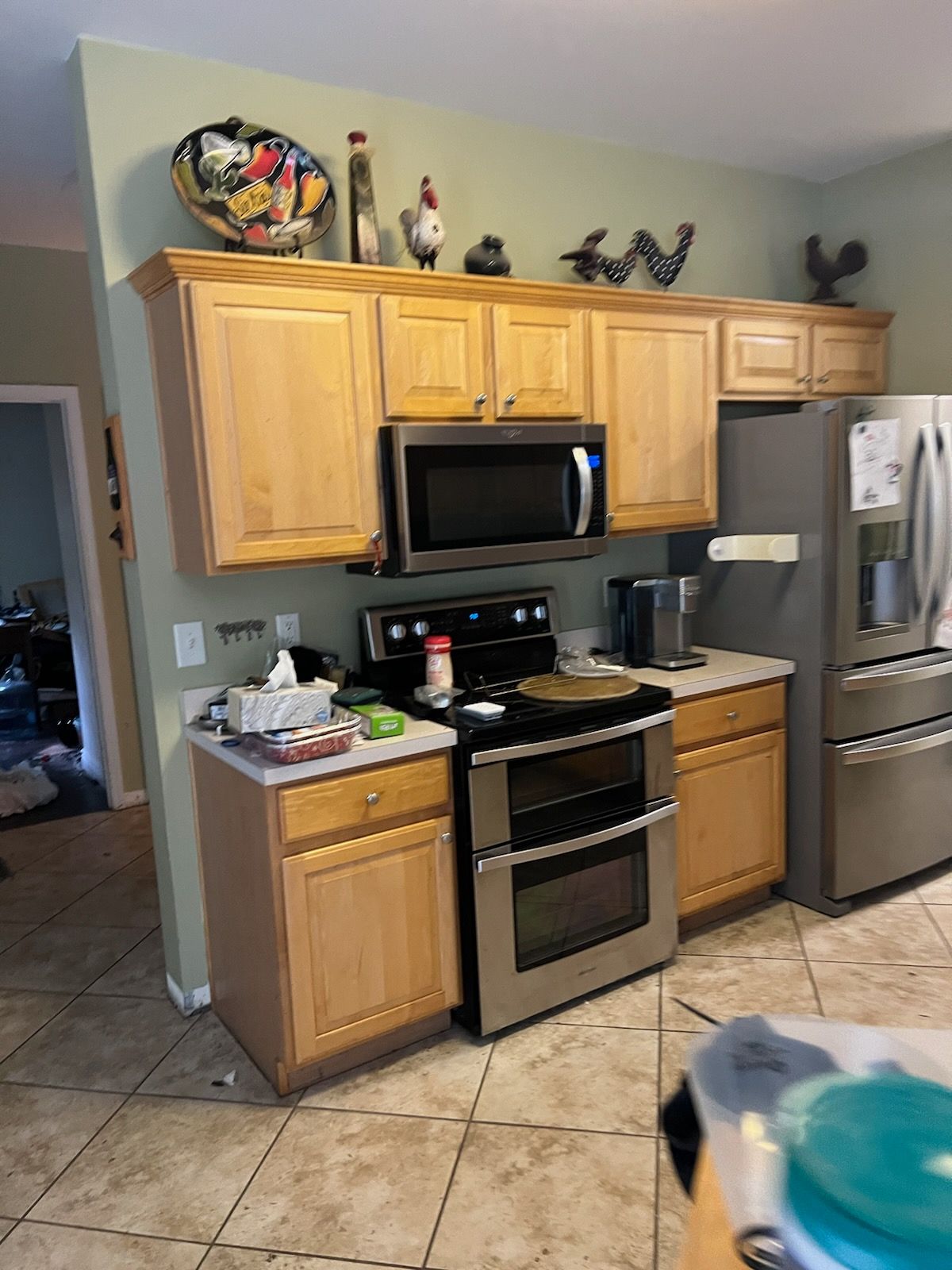 A kitchen with stainless steel appliances and wooden cabinets.