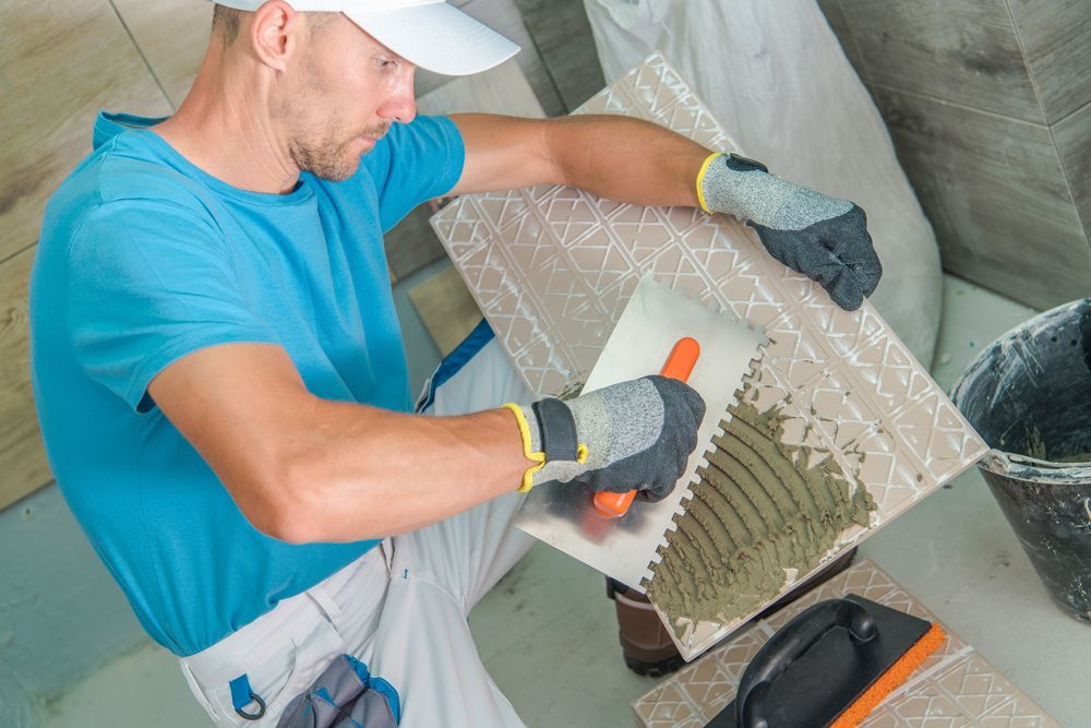 Professional Worker Installing New Tiles for Bathroom
