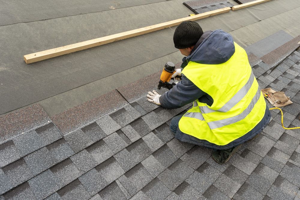 Professional Worker Installing New Shingle Roof