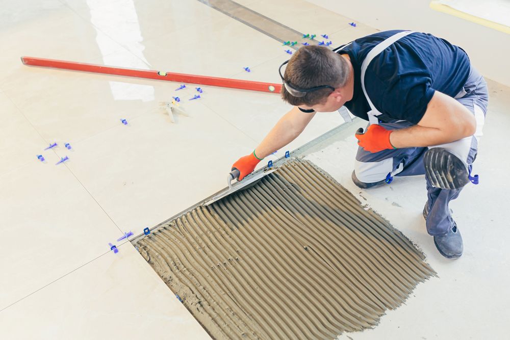 Professional Worker Installing New Tiles
