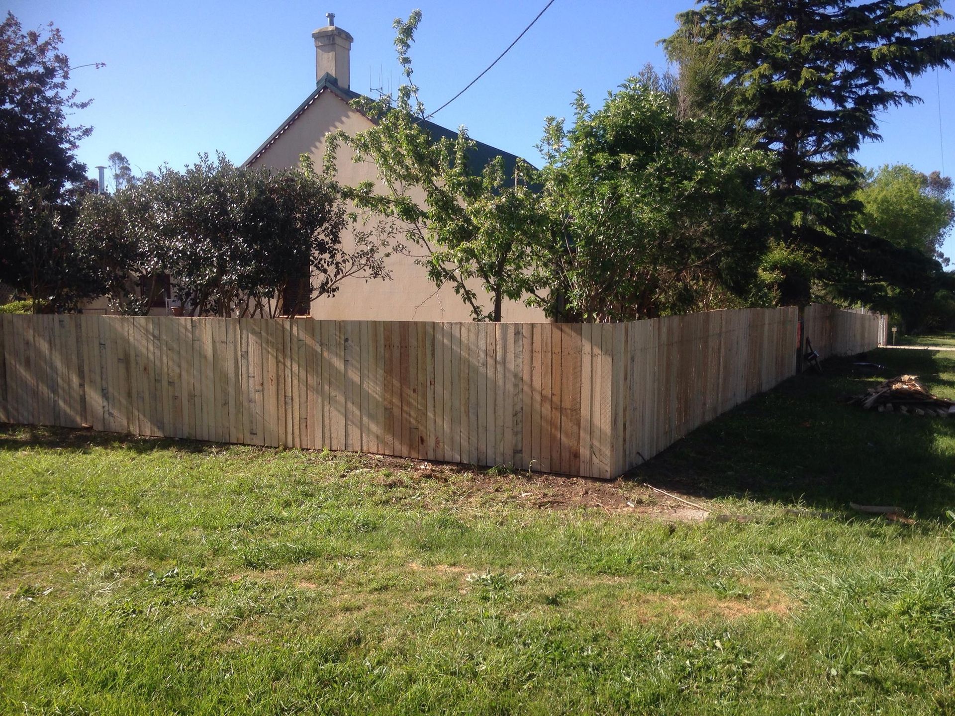 A house with a wooden fence in front of it