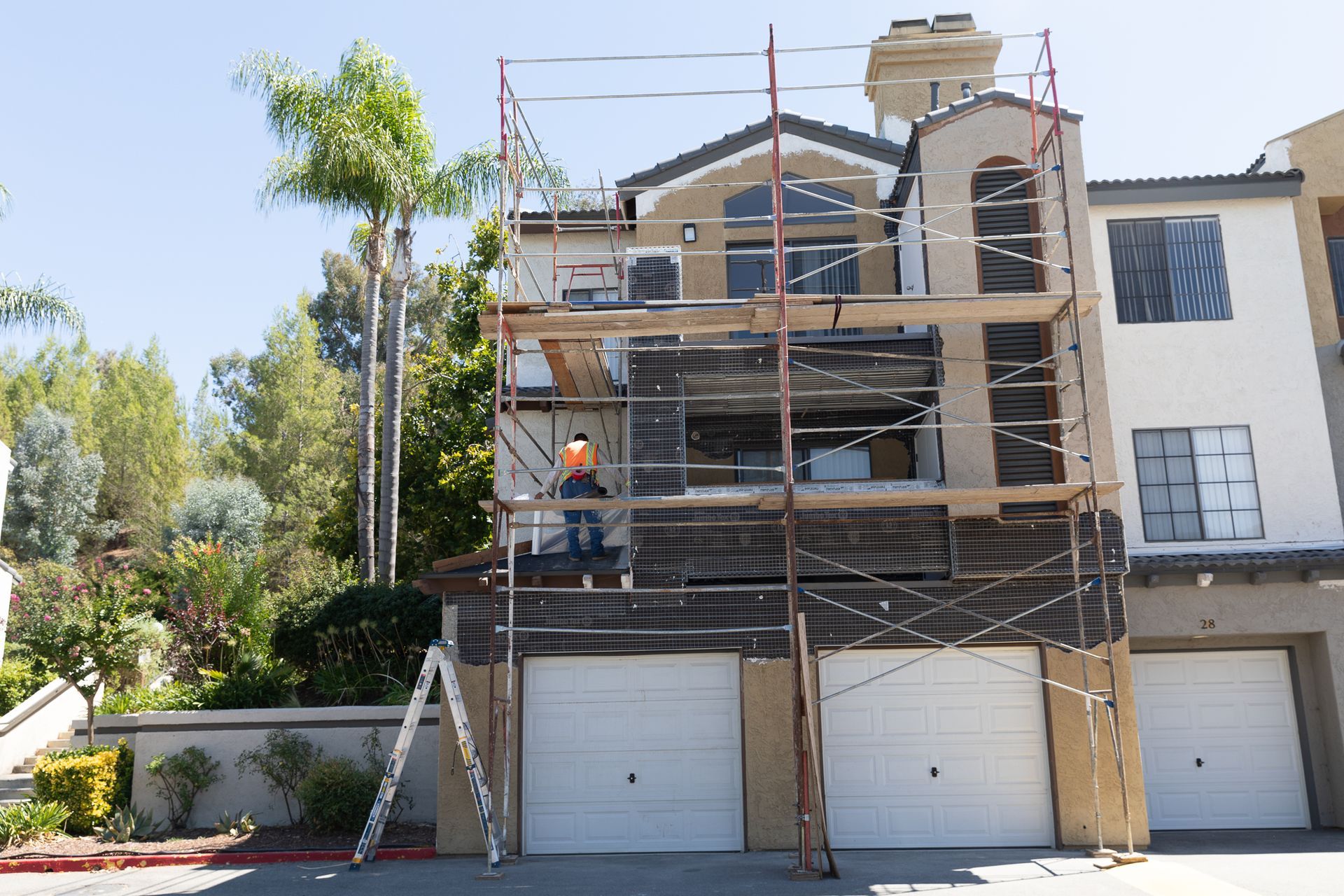 A house is being remodeled with scaffolding around it
