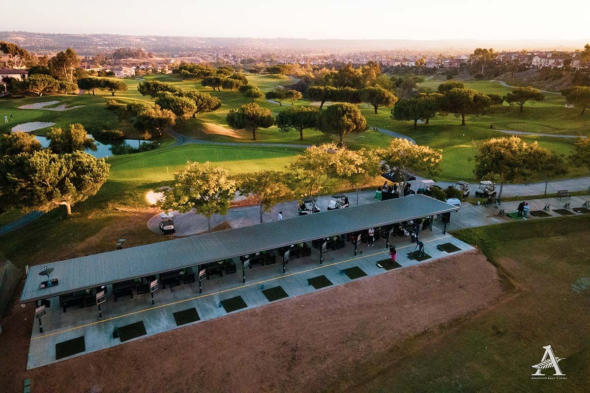 An aerial view of a golf course with people playing golf.