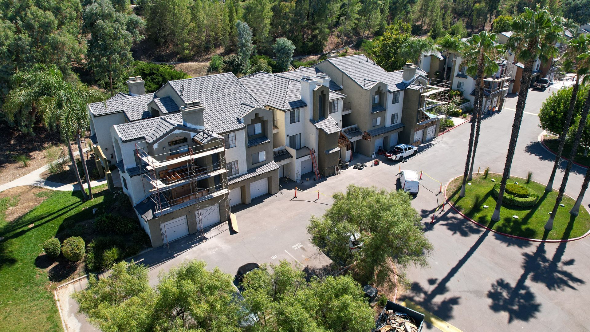 An aerial view of a residential area with lots of trees and buildings
