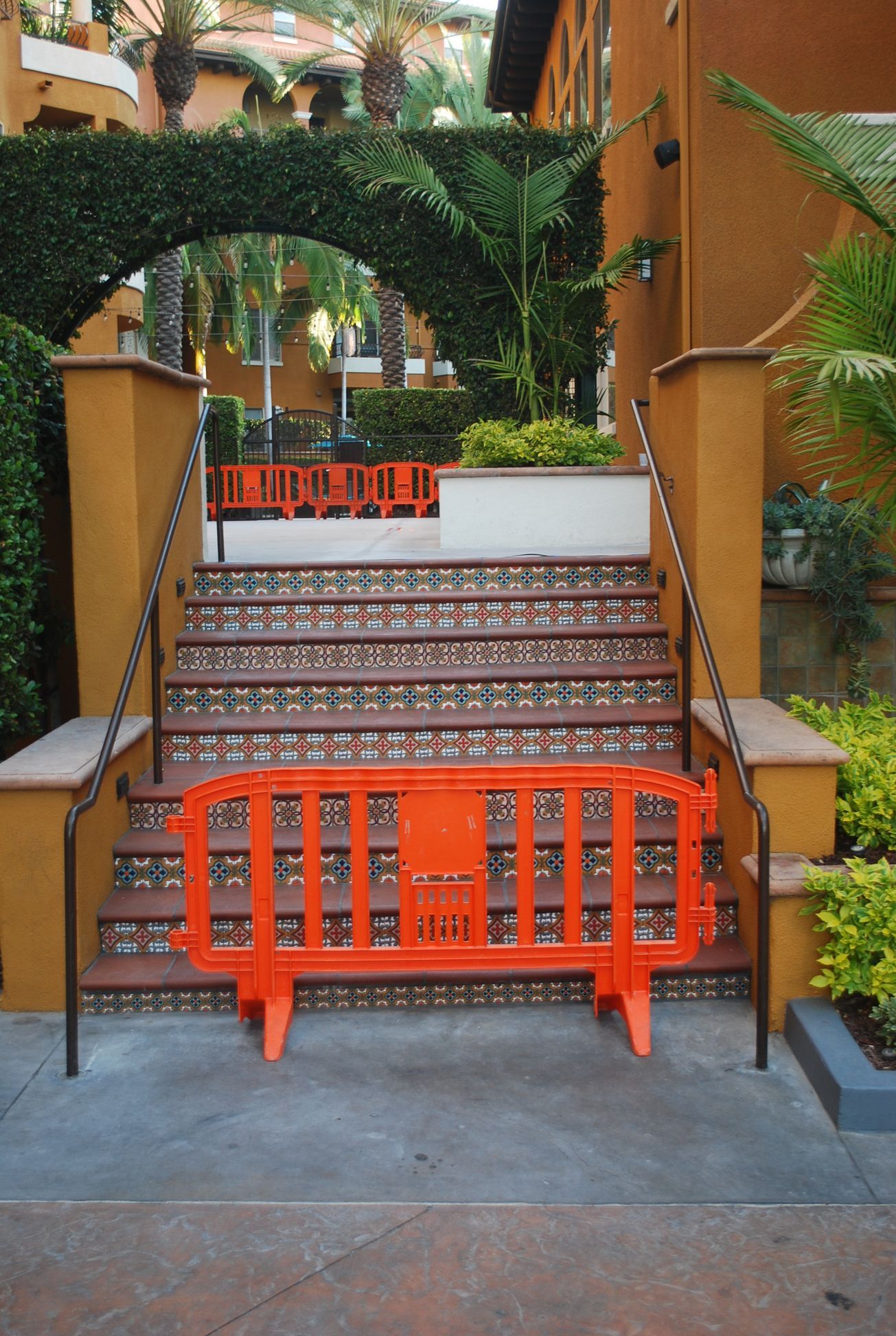 An orange barrier is sitting in front of a set of stairs