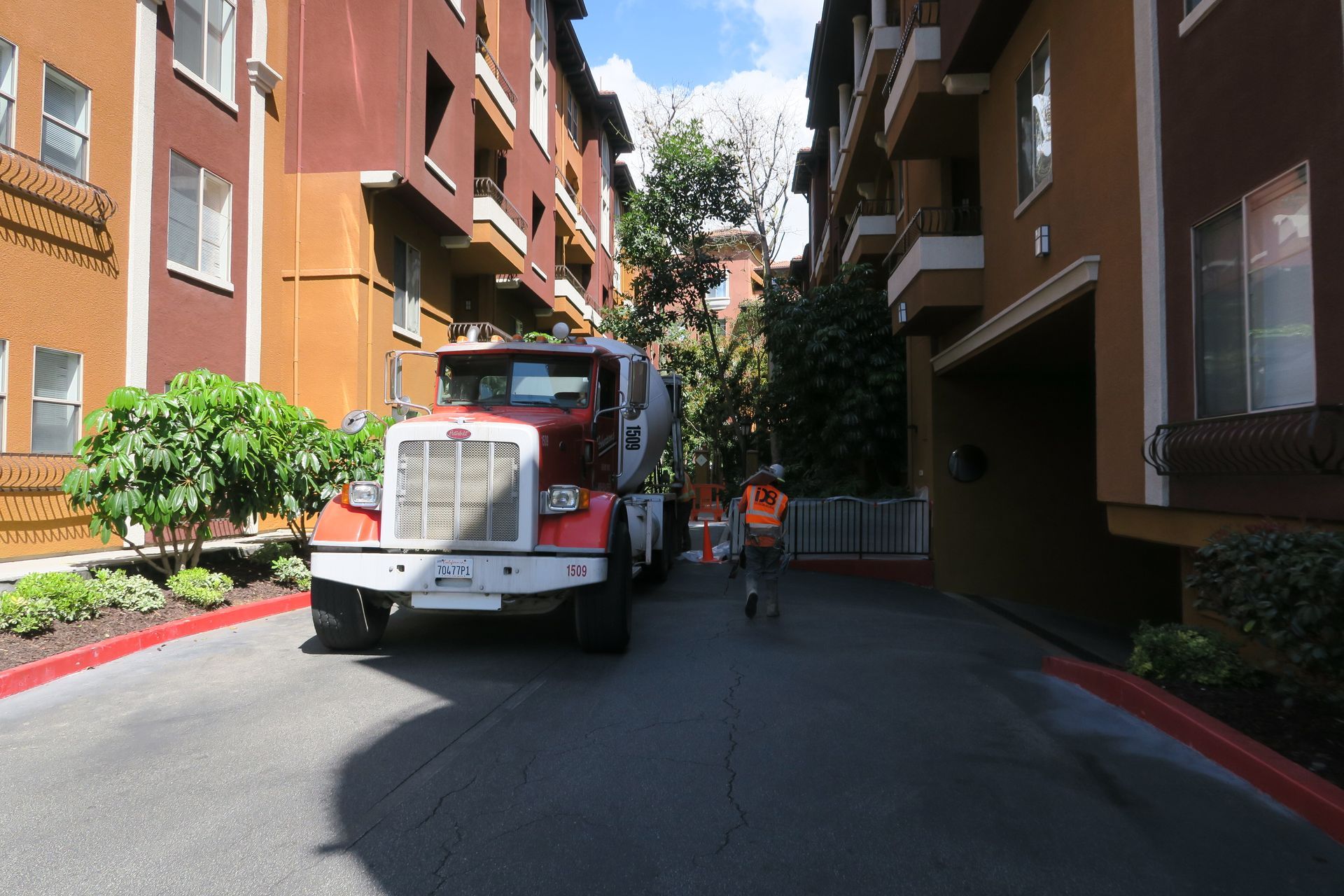 A red and white truck is parked in a parking lot