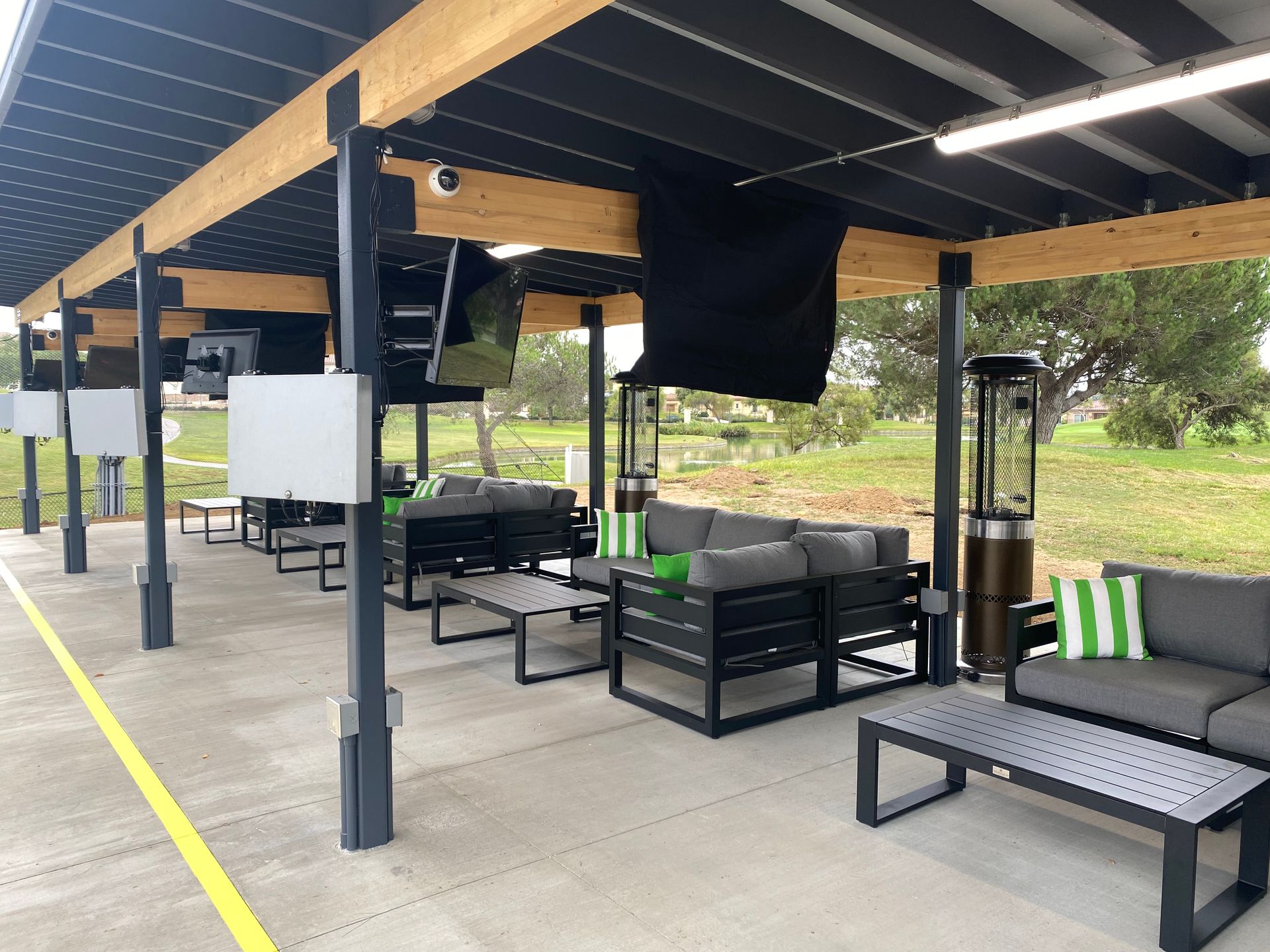 A patio area with a lot of furniture and a heater.