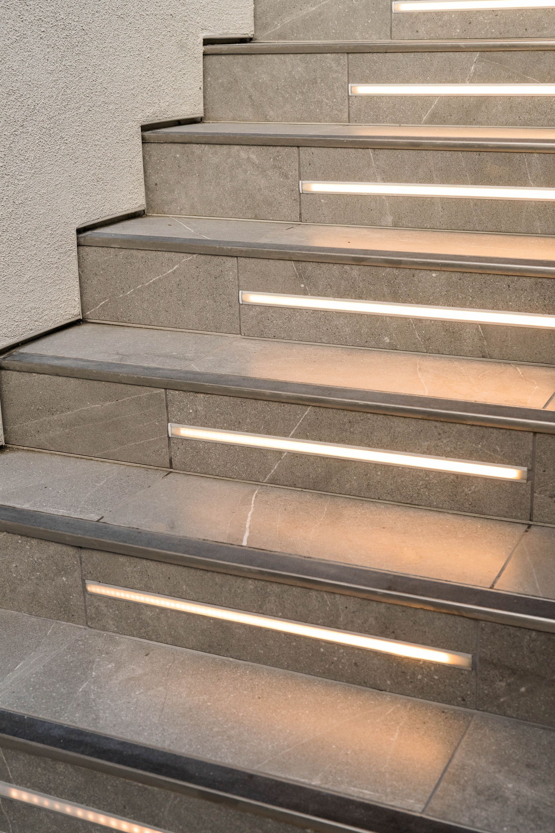 A close up of a set of stairs with lights on the steps.