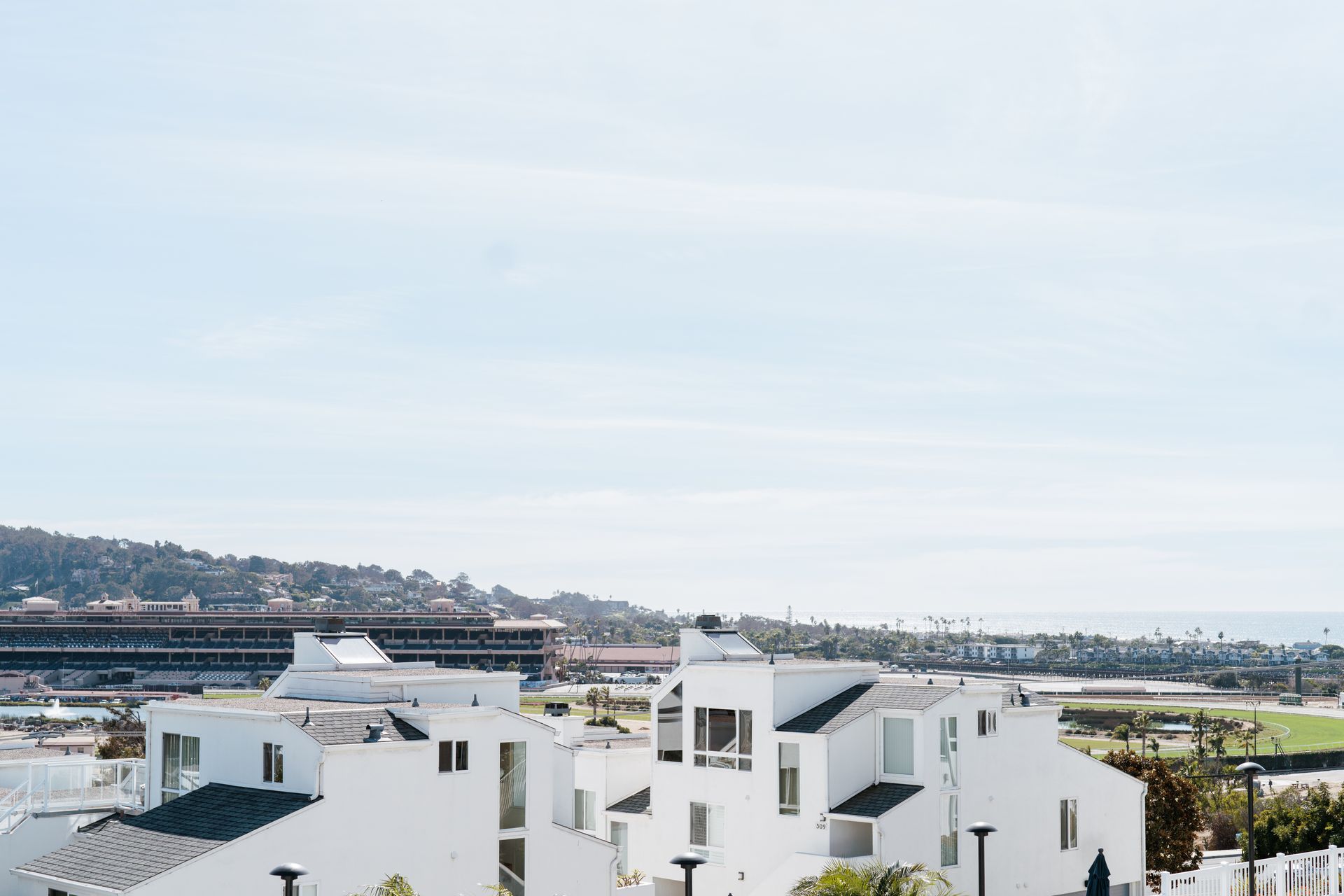 A row of white houses with a view of the ocean