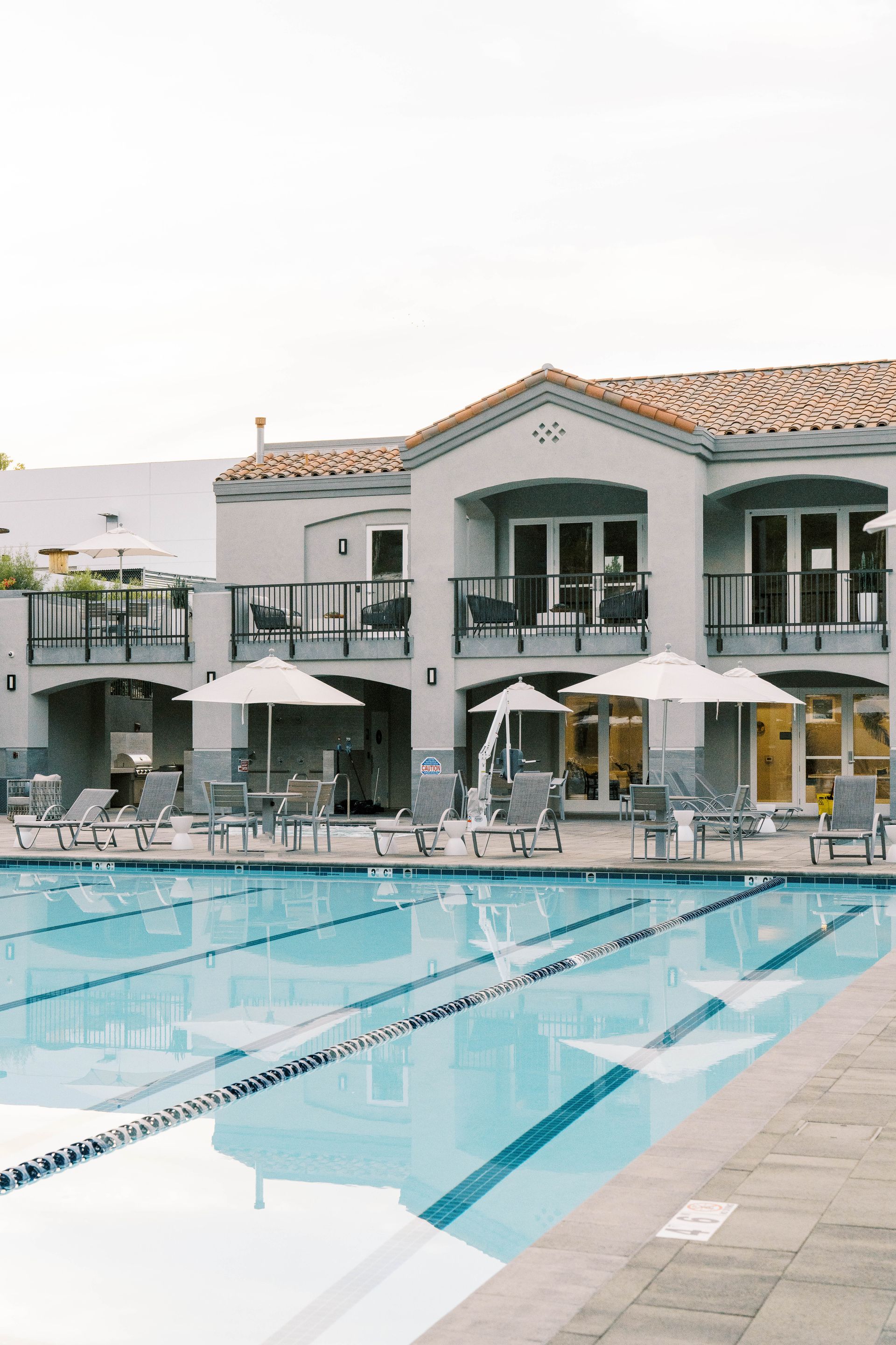 A large house with a large swimming pool in front of it.