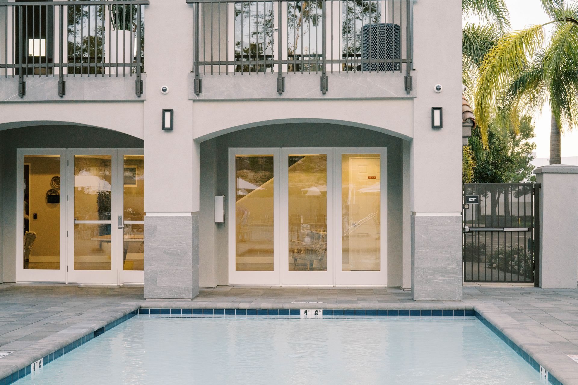 A large building with a swimming pool in front of it