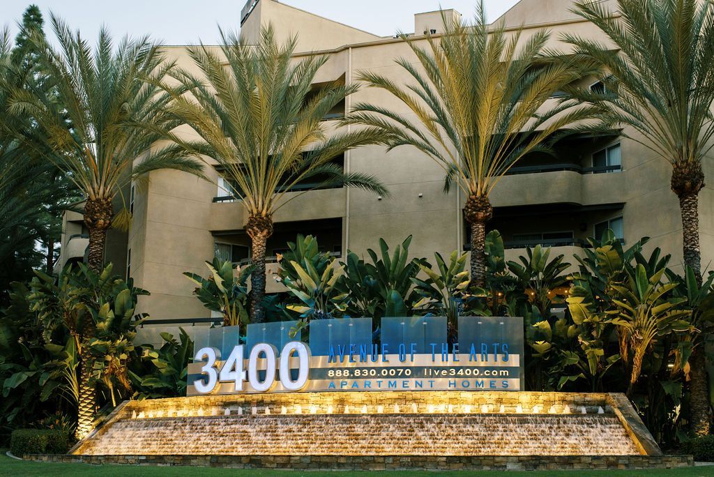 A building with palm trees and a sign that says 3400