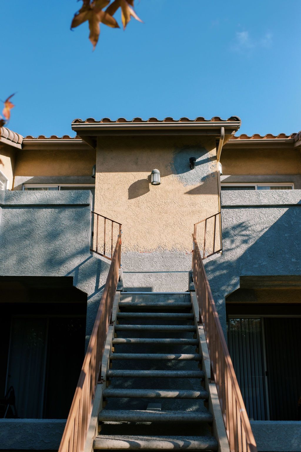 A building with stairs leading up to the second floor