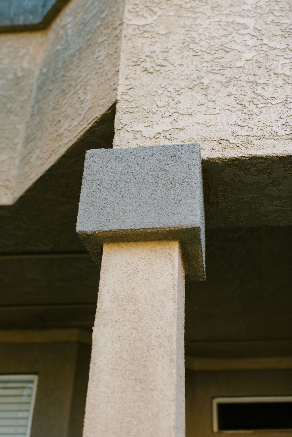 A close up of a concrete column on the side of a building.