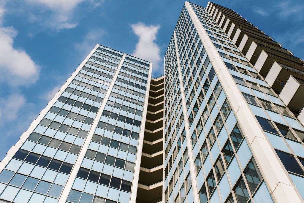Looking up at a tall building with a blue sky in the background