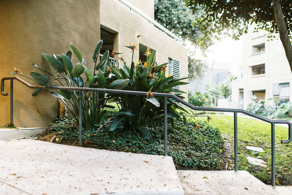 A staircase with a railing leading up to a building